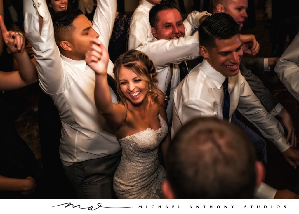 Bride Dances with Groomsmen at Wedding