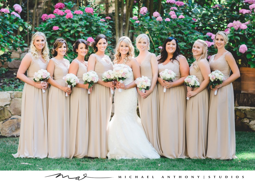 Radiant Bride and Bridesmaids in Nude Dresses with Pink Bouquets