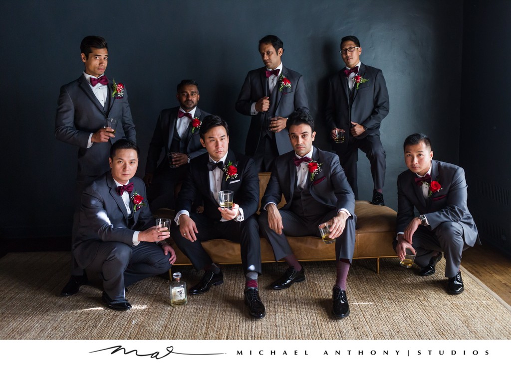 Groomsmen in Stylish Grey Suits Enjoying a Pre-Wedding Toast