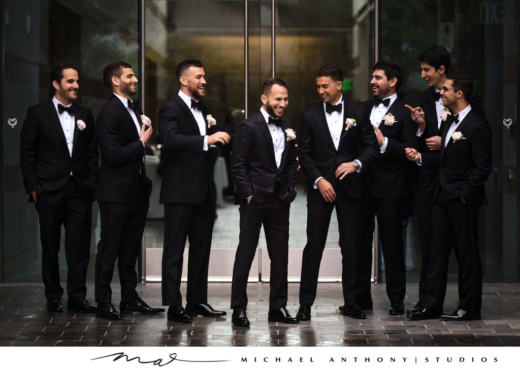 Groomsmen Sharing a Laugh in Classic Black Tuxedos