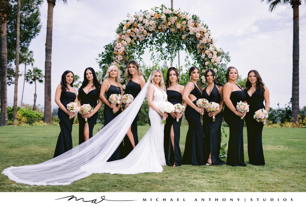 Elegant Outdoor Bridal Party Under Floral Arch