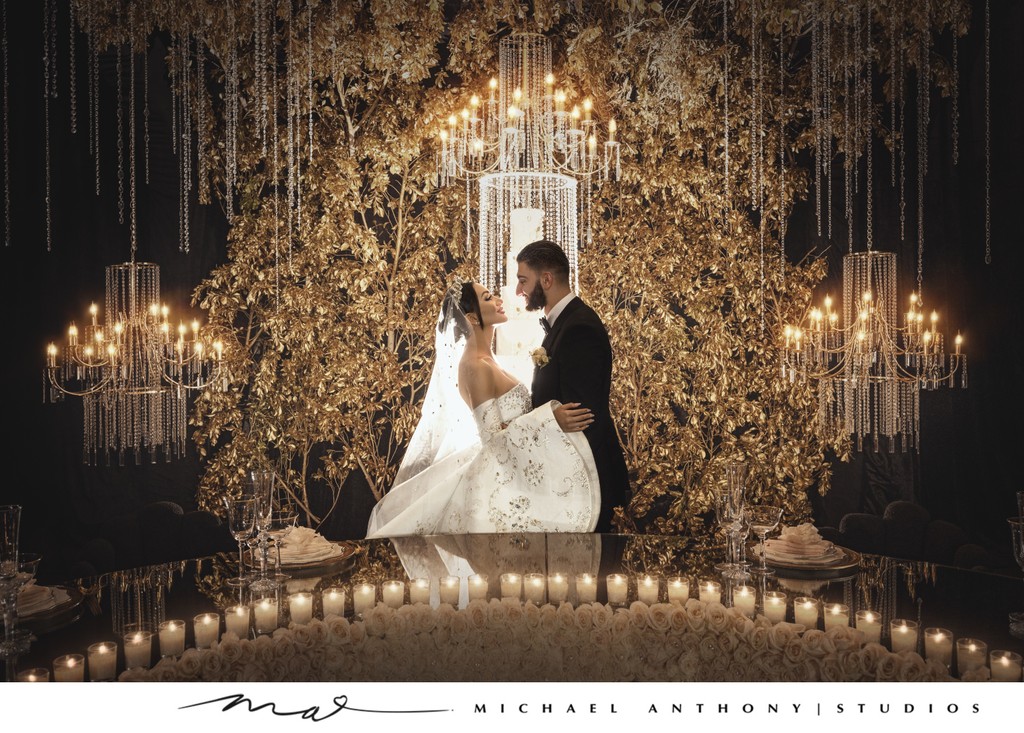 Bride and Groom Posing with Floral Display at Night