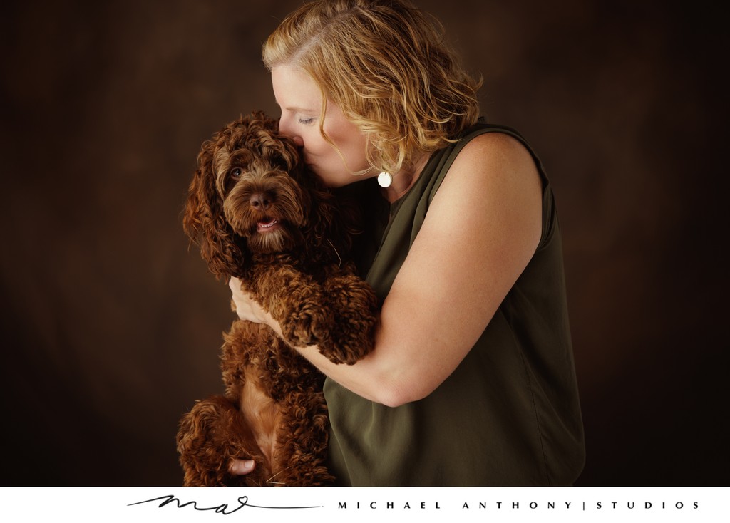 Woman Kissing Dog Portrait