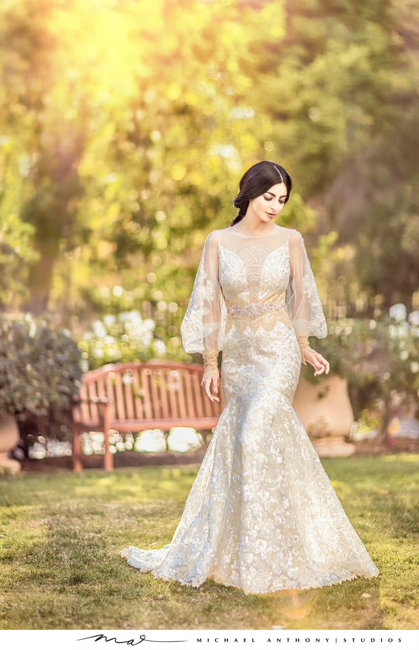 Bride stands in courtyard at hotel during wedding