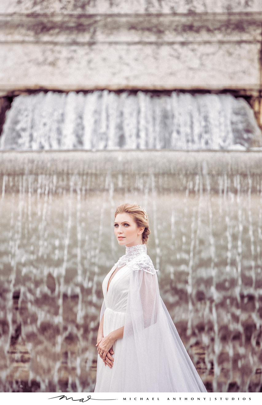 Bride standing in front of waterfall