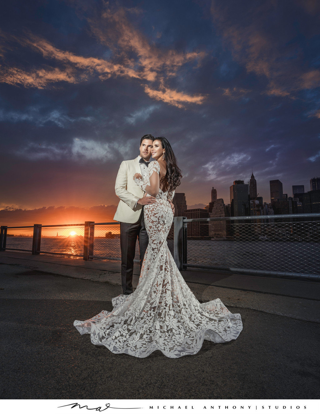 Couple posing in city at sunset