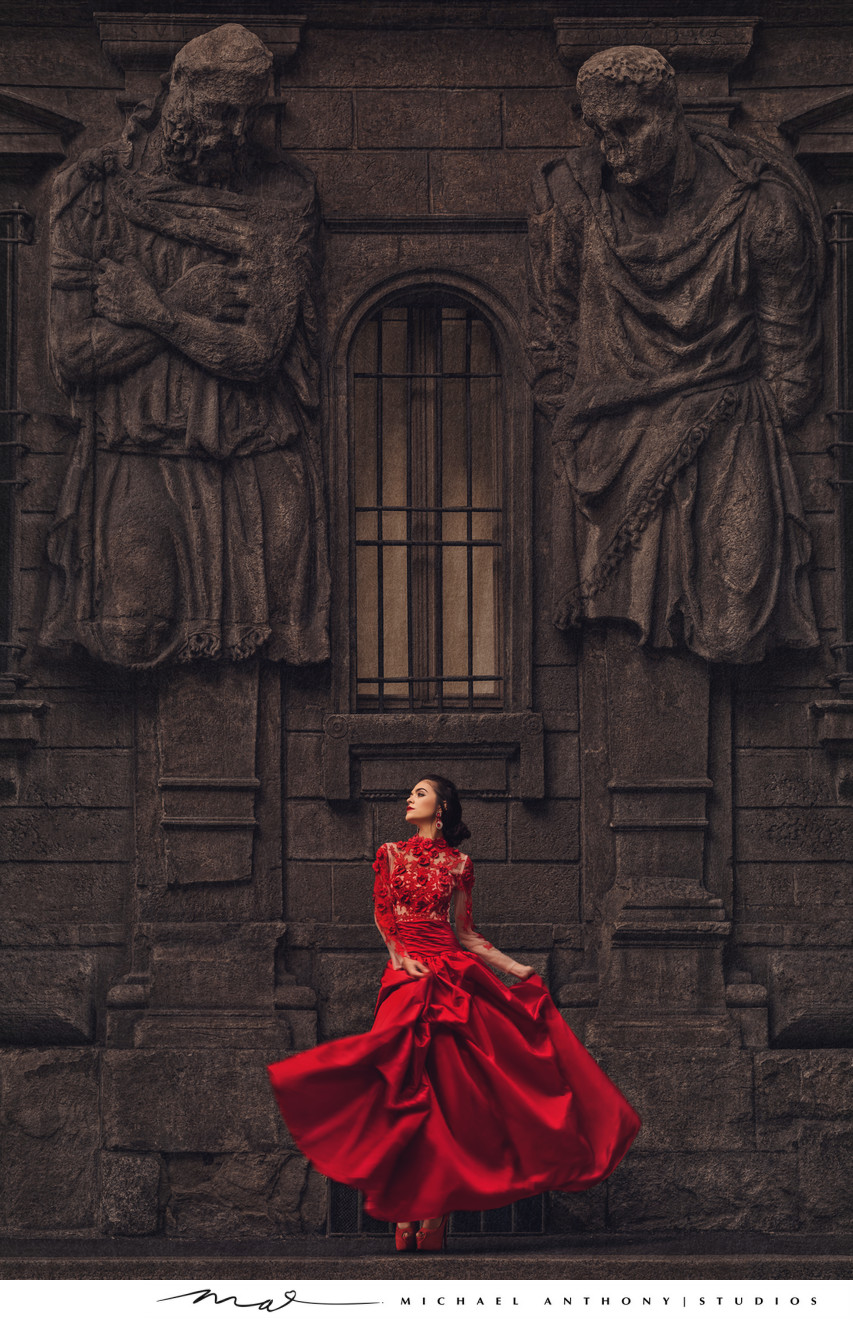 Bride in Red Wedding Dress Twirls Under Statues