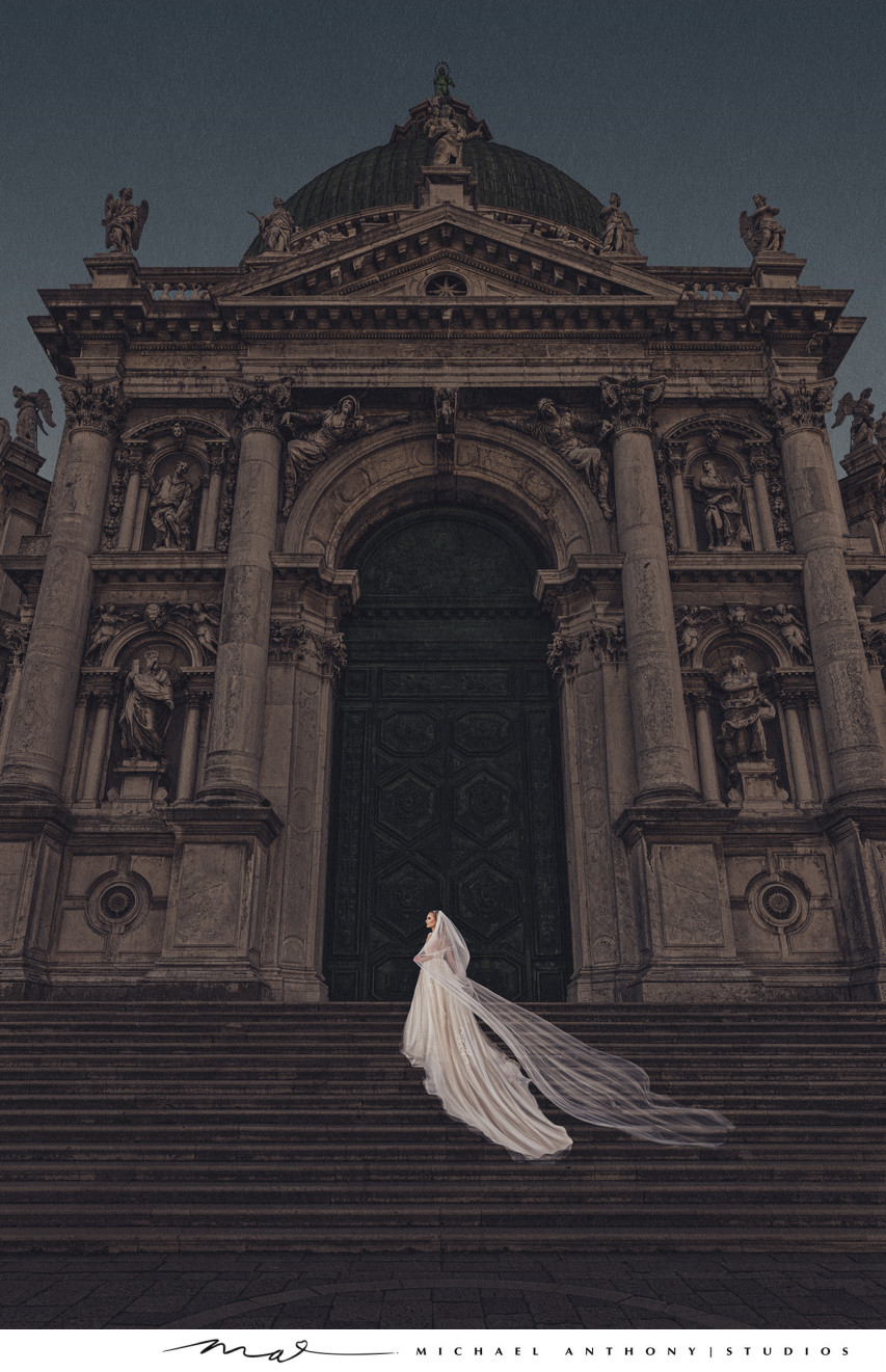 Bride poses on steps of Cathedral in Venice.