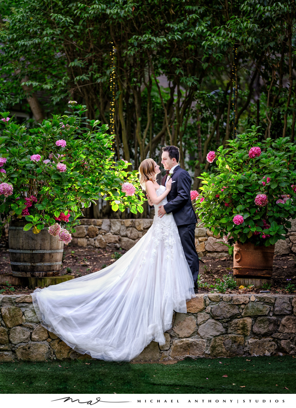 Bride and Groom Embrace in Garden Setting