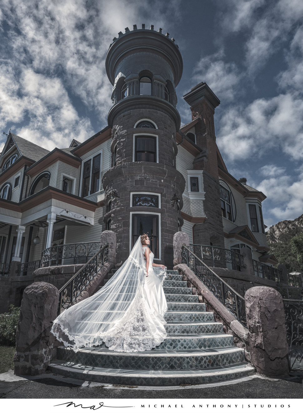 Bride standing on stairs of Stunning Mansion