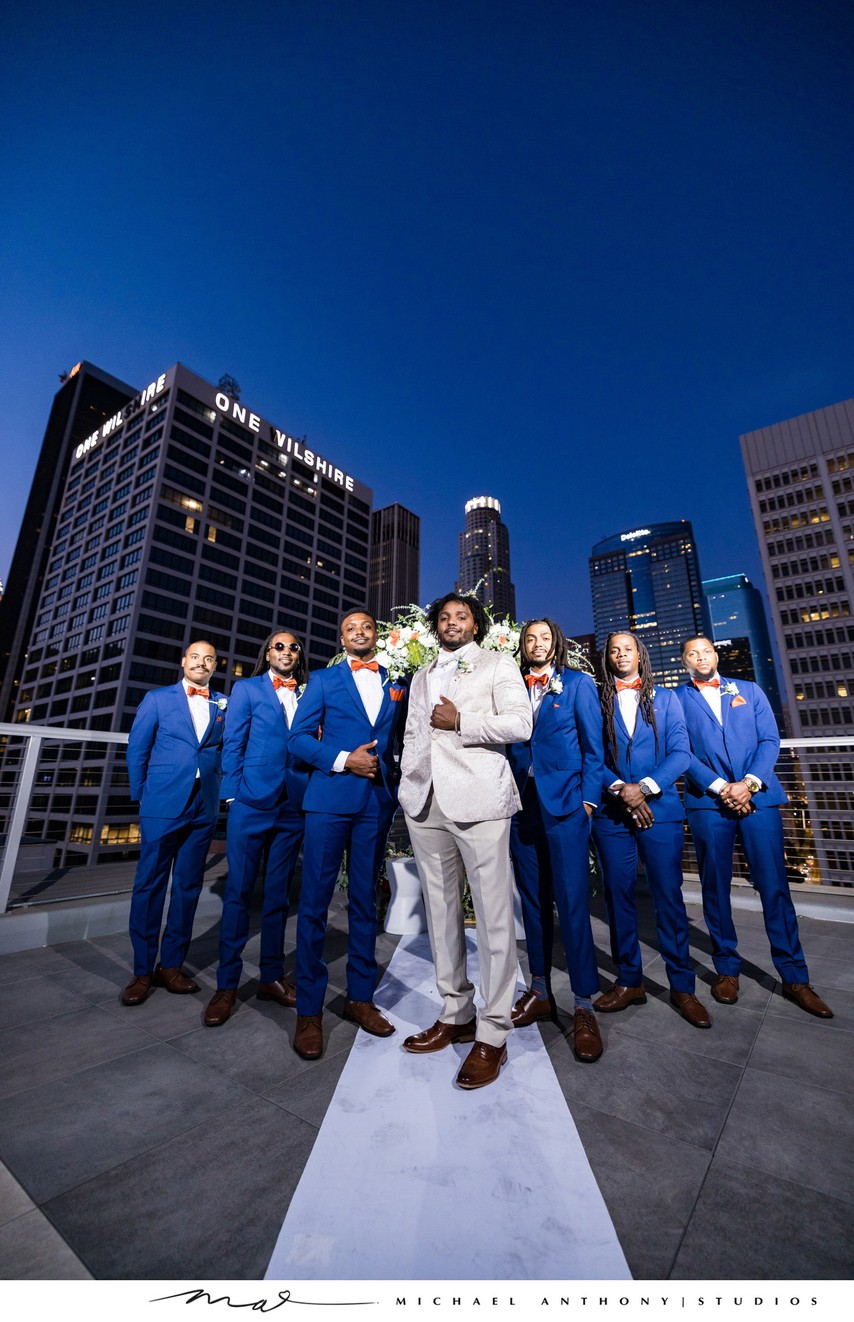 Groomsmen on a Rooftop Against the City Skyline at Dusk