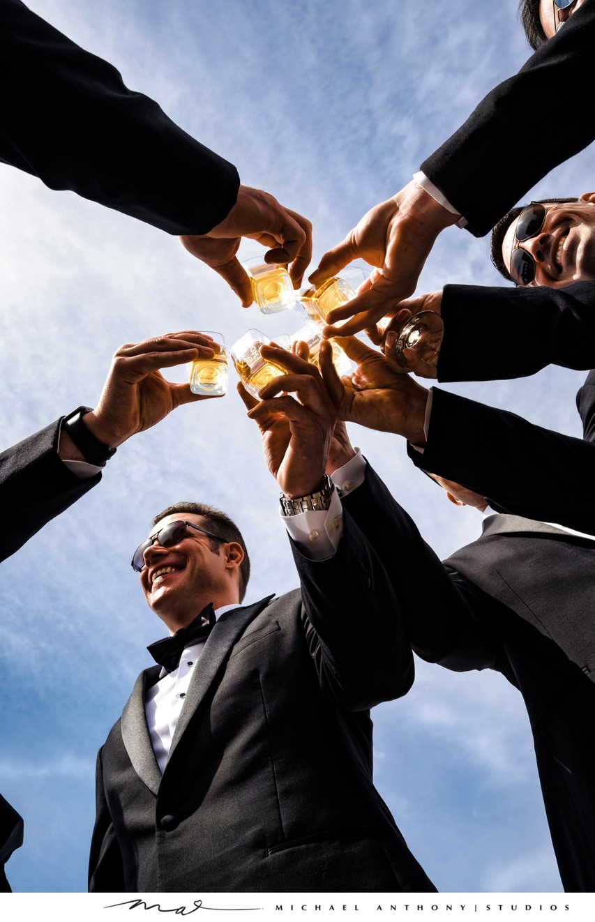 Groomsmen Toasting with Whiskey Under the Blue Sky