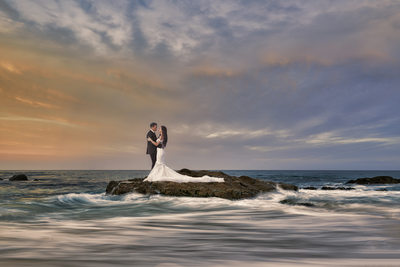 Bride and Groom posing on a Beach in Cabo