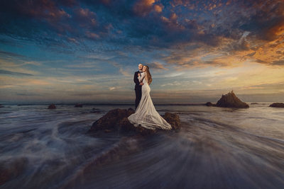Wedding Couple poses on Beach at High Tide