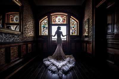 A Bride in front of stained glass at Newhall Mansion