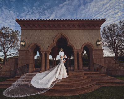 Bride and Groom Pose on Stairs at Fairmont Grand Del Mar