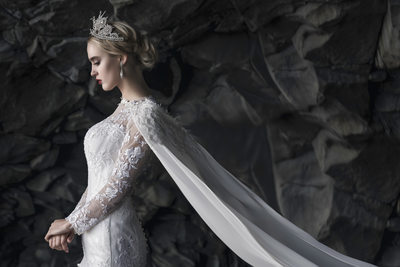 Regal Bride standing in Icelandic Cave