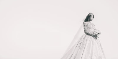 Bride poses against sky in Black and White Portrait