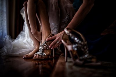 Bride puts on Shoes Before Wedding