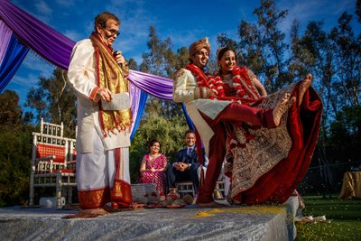 Indian Couple Kicking Rice During Akshata at Wedding