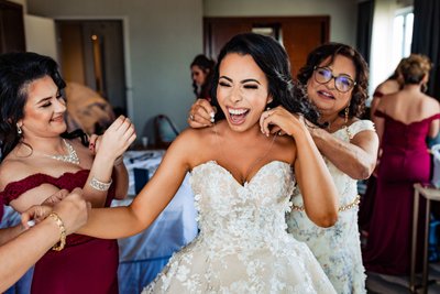 Bride Laughs While Getting Ready