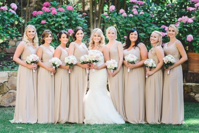 Radiant Bride and Bridesmaids in Nude Dresses with Pink Bouquets