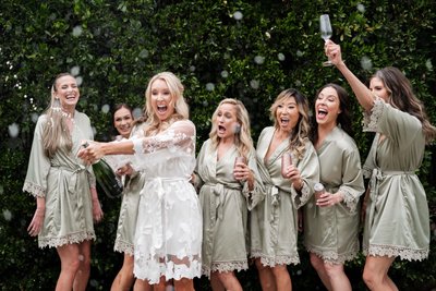 Bride and Bridesmaids Celebrating with Champagne
