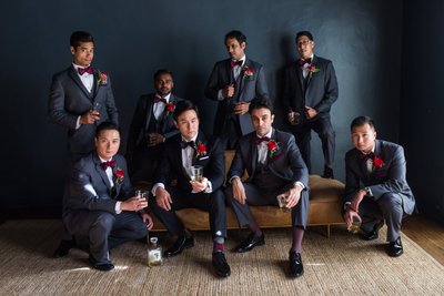 Groomsmen in Stylish Grey Suits Enjoying a Pre-Wedding Toast