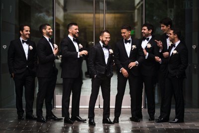 Groomsmen Sharing a Laugh in Classic Black Tuxedos