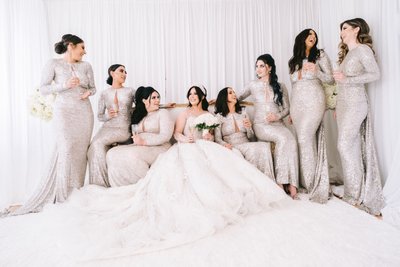 Bridal Party in Silver Gowns Celebrates with Champagne