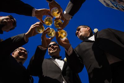 Groomsmen Toasting Under a Clear Blue Sky