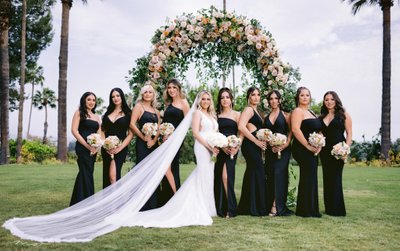 Elegant Outdoor Bridal Party Under Floral Arch