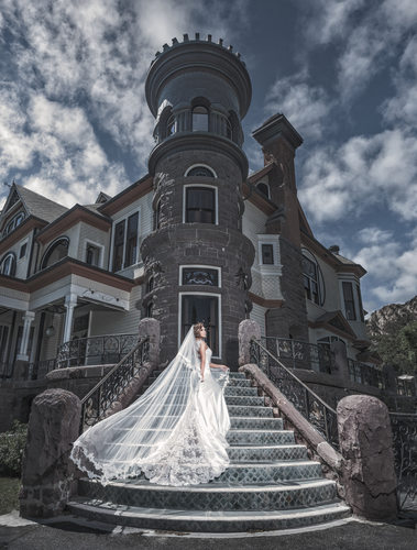 Bride standing on stairs of Stunning Mansion