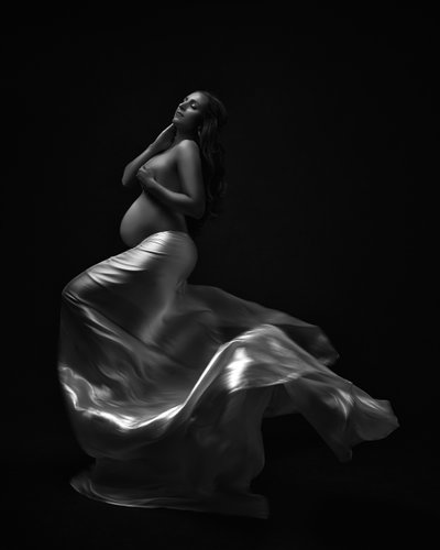 Dramatic Black and White Maternity Portrait with Flowing Silk