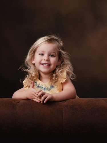 Joyful Little Girl in Yellow Dress Portrait