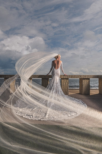 Bride at Beach with Veil Flowing