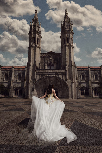 Bride poses in front of beautiful cathedral