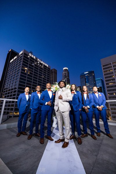 Groomsmen on a Rooftop Against the City Skyline at Dusk