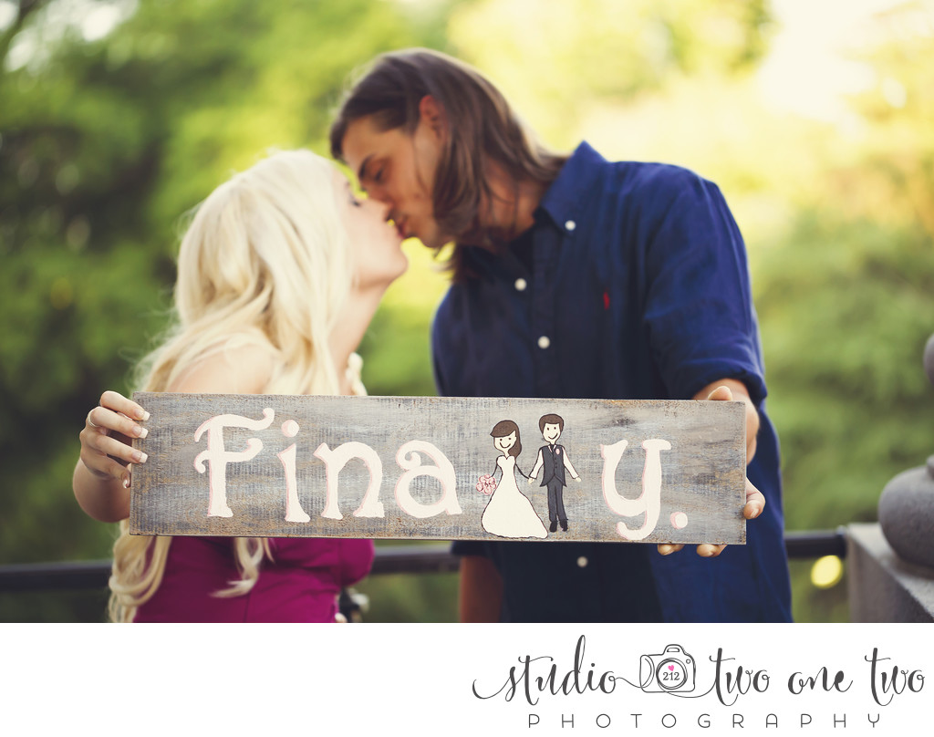 Engagement photo with wooden sign
