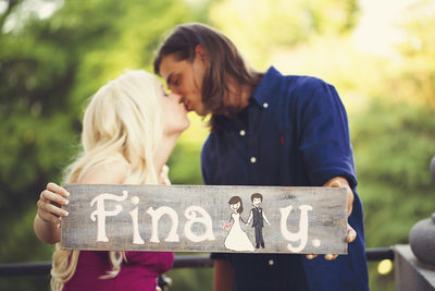 Engagement photo with wooden sign
