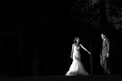 bride reaches for groom at holland lake lodge wedding