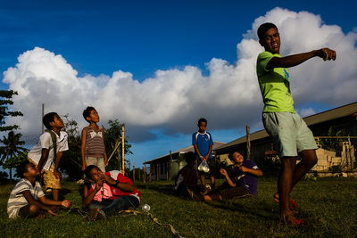Tongan Boy Holds Kite While Friends Look On