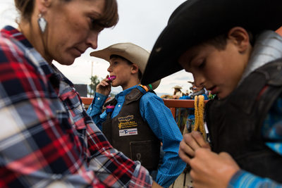 Cowboy Adjusts Mouth Guard Before Bull Ride in Montana