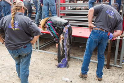 Injured Bronc Rider at Drummond, Montana Rodeo