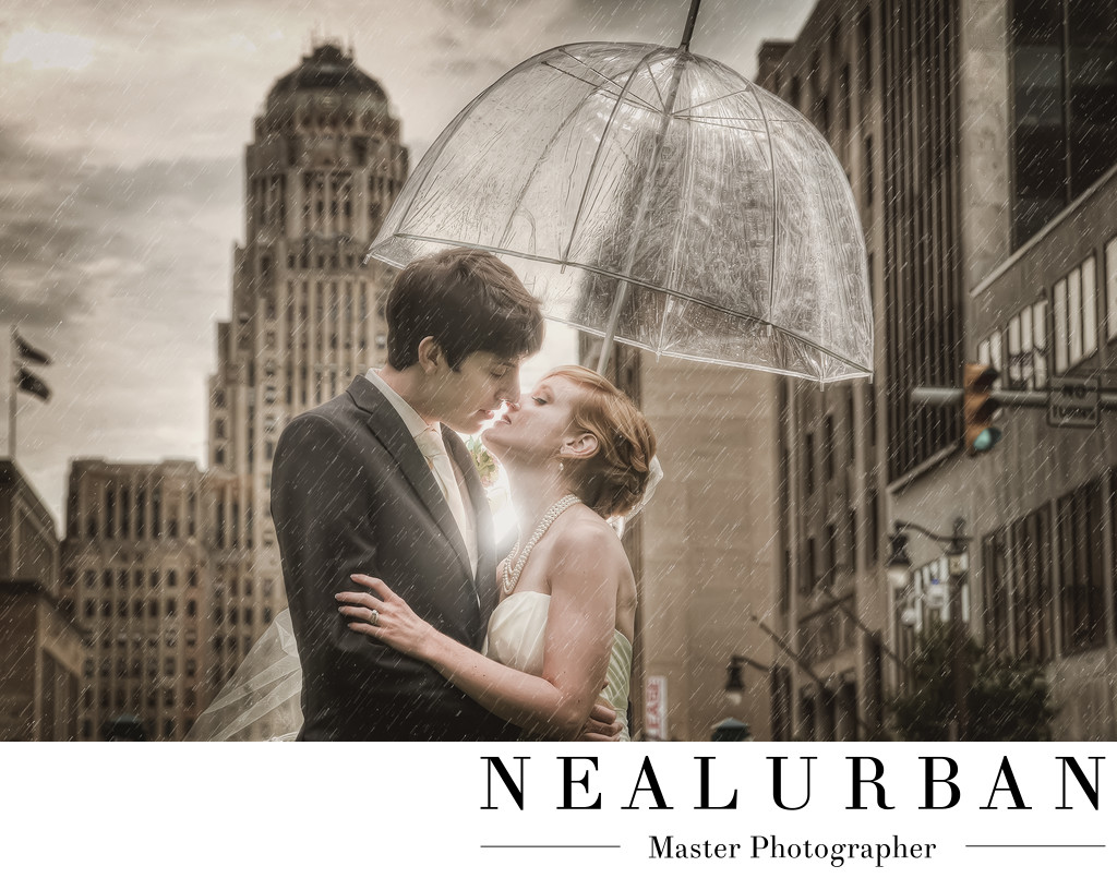 buffalo wedding photographers bride and groom in the rain umbrella