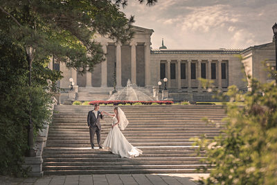 Bride and groom on the stairs at delaware park with albright knox