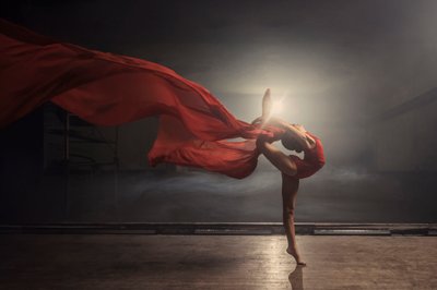 Dancer on Stage with Flowing Material