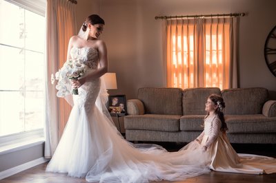 Flower girl helping bride get ready