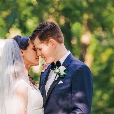 Bride and groom kiss on the river bridge ancaster mill