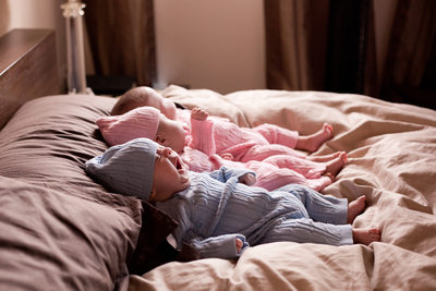 Baby triplets in bed